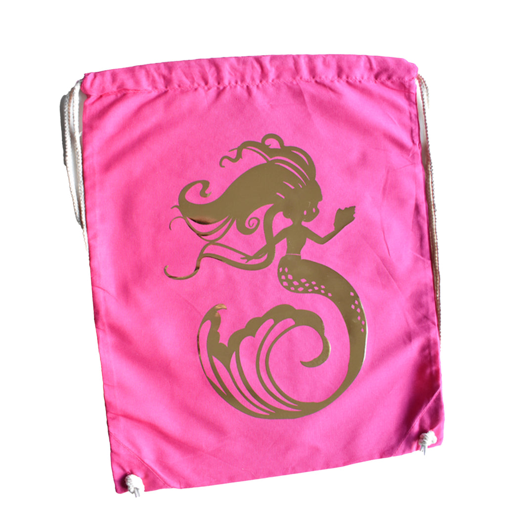 A pink drawstring bag with gold mermaid design by Sonya Bull